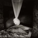 Emmett lying on bed with mosquito ned tied above him, Sheet Changing Day, from Immediate Family series by Sally Mann
