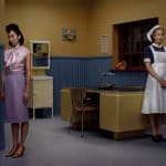 Erwin Olaf photograph of woman in doctor's office with nurse standing on other side of the room