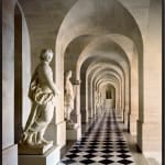 Framed photograph of Versailles hallway in travertine with sculptures and checkered marble floor by Robert Polidori
