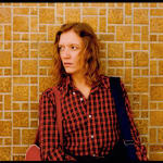 Ginger Shore against brick wall by Stephen Shore