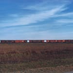 William Eggleston, Train Cars in Field, from the Southern Suite Portfolio, 1971