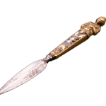 Dutch penknife with an enameled handle topped with a Bust of Bacchus, detail showing floral pattern in dark blue and gold, with ornate geometric design and silver base. Close-up photograph highlighting decorative craftsmanship.