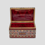 Enameled glass and metal rectangular casket, circa 1900 A glass bombé top casket decorated with geometric, colourful motifs and Kufic verses, with metal mounts 20 x 32 x 18.5 cm