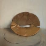 hazy still life pastel drawing of slightly crumpled circular cardboard packing material leaned against a wall.