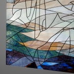 Room with a dark blue, green and orange stained glass window made up of 3 panels against a plain wall Rindon Johnson Clattering, 2021 Stained glass work (3 panels) and ash wood bench Glass work: 360 x 158 cm 141 3/4 x 62 1/4 inches Bench: 200 x 49 x 80 cm 78 3/4 x 19 1/4 x 31 1/2 inches