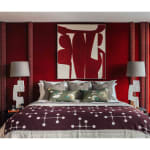 Pair of white marble table lamps beside red bedroom