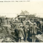 The Associated Illustration Agency, LTD. London, German Offensive 1918. Busy scene on a road. British troops pushing huge canon to...