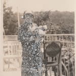 John Latour, Woman with Fur Trimmed Coat Holding a Bouquet of Flowers, 2021