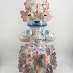 Back view of the ceramic sculpture “Tattooed Space Monkey” (2025) by Kartini Thomas, featuring intricate blue drawings, and pink-edged protuberances.