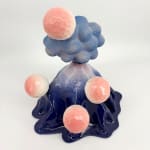 Front view of a ceramic volcano sculpture by Kartini Thomas featuring glossy deep blue glaze and pastel pink faceted spheres.