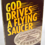 God Drives a Flying Saucer. A Totally New and Revolutionary Concept of UFO's, Their Existence and Their Meaning. Front cover
