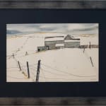 The frame of "Nestled in the Hills, 1969" by John Kasyn is an artwork that captures the stark beauty of a rural winter landscape. The composition features a series of farm buildings nestled against a backdrop of rolling hills.