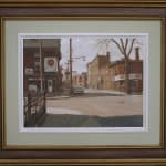 A framed photo of Old brick buildings and a vintage car