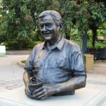 Angled view of the bronze bust of Bill Roche holding a potted plant, installed at Hunter Valley Gardens, symbolizing his legacy.