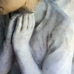 The marble angel with fingers missing and the start of sculpting the new head in plasticine.