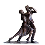 A frontal view of a bronze statuette of a tango-dancing couple. The male dancer gazes at his partner as they hold a dramatic pose, highlighting the connection and energy of their dance.