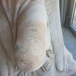 The effects of acid rain on the knee of a marble angel