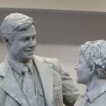 clay model depicting two figures from the Shore Boys statue. A taller figure in a suit and tie interacts warmly with a younger boy in school uniform, emphasizing mentorship and connection.