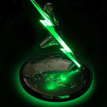 The Lightning Trophy from a top perspective, showcasing its green neon lightning bolt, the leaping human figure, and the globe-etched base, all illuminated with an intense green glow, creating a sense of energy and movement.