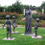 Outdoor bronze sculpture series featuring children and a grandmother interacting in various playful and loving poses at Hunter Valley Gardens