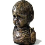 A miniature bust of a child in bronze, showcasing a soft and innocent expression. The sculpture captures the delicate features of a young face, with subtle details in the hair and garment folds.