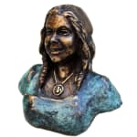 A bronze mini-bust of the daughter with a unique blue patina finish. Her braids and gentle smile are meticulously crafted, with a medallion necklace adding a personal touch to the piece.