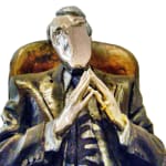 Detail of the upper body of a resin sculpture titled Chairman depicting a seated male figure in a suit. The man is portrayed in a thoughtful pose, leaning back slightly in a high-backed chair with his legs crossed and hands clasped together. The figure’s head and hands have chrome finishes, contrasting with the darker patina of the suit and chair. The piece exudes authority and contemplation.