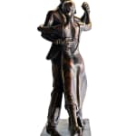 A bronze statuette depicting a couple dancing the tango. The male dancer holds the female dancer close as they move gracefully, the detailed folds of her dress swaying with the motion.
