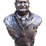 This image showcases a bronze bust of Lindsay Fox, sculpted by Linda Klarfeld. The sculpture portrays Fox with a stern and commanding expression, capturing his iconic presence. The textured surface of the bronze adds depth and vitality to the piece, reflecting the sculptor's attention to character and detail. The bust emphasizes Fox's role as a notable business figure, rendered with both strength and artistic nuance.