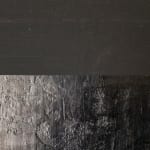 Detailed view of the edge where the dark surfaces meet, highlighting the intricate textures and varying shades of gray and black. The artwork's edge accentuates the physical boundaries of the canvas, reinforcing the idea of the painting as an object and a portal into a contemplative psychological space