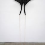 A mosaic sculpture by Leah Shirley in the shape of a moth with black wings. A delicate copper chain extends from the moth's two lower wing edges and stretches to the floor.