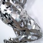 Stainless steel sculpture of a person laying on their side with their arm under their head by slate gray gallery artist David Davis
