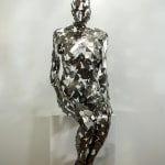 Stainless steel sculpture of a person sitting upright by slate gray gallery artist David Davis