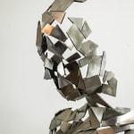 Stainless steel sculpture of a person sitting upright by slate gray gallery artist David Davis