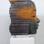 "Mind Bending" a sculpture of a face made from wooden sticks and paint by slate gray gallery artist Gil Bruvel