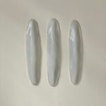 White Ceramic petals that can be arranged in multiple ways by slate gray gallery artist Angela Okajima-Kempinas