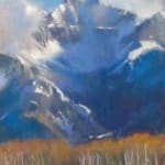 Pastel painting of a snowy mountain with yellow trees in front of it by slate gray gallery artist Bruce A. Gomez