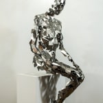 Stainless steel sculpture of a person sitting upright by slate gray gallery artist David Davis