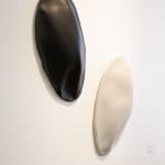 Black and white ceramic petals that can be arranged in multiple ways by slate gray gallery artist Angela Okajima-Kempinas