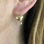 18k yellow gold bird earrings with bezel set diamonds by Fringe Gallery studio jeweler Sandra Frias