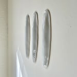 White Ceramic petals that can be arranged in multiple ways by slate gray gallery artist Angela Okajima-Kempinas
