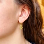 Yellow gold scroll earrings with four diamonds by Fringe Gallery studio jeweler Nanci Modica