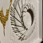 "Whiteout" a wood wall sculpture painted mostly white with a gold accent by slate gray gallery artist cie hoover