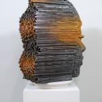 "Mind Bending" a sculpture of a face made from wooden sticks and paint by slate gray gallery artist Gil Bruvel