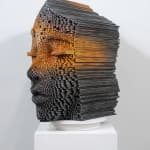 "Mind Bending" a sculpture of a face made from wooden sticks and paint by slate gray gallery artist Gil Bruvel