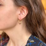 Yellow gold skinny hoops by Fringe Gallery studio jeweler Nanci Modica