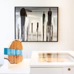 An abstract view of Native Americans walking off in the distance made with acrylic, resin, and feathers on canvas by Fringe Gallery artist Fran J Nagy