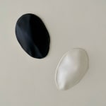 Black and white Ceramic petals that can be arranged in multiple ways by slate gray gallery artist Angela Okajima-Kempinas
