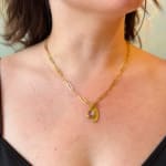 Yellow gold oval pendant with diamonds by Fringe Gallery studio jeweler Nanci Modica