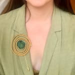Brooch, woven palm and emerald slice by Slate Gray Gallery studio jeweler Sandra Frias